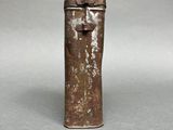 an image of a small metal container with a handle on a table