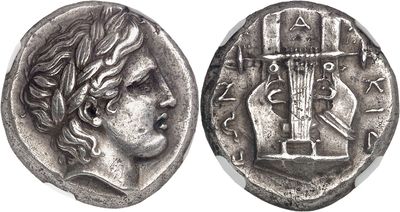 a silver coin with a woman ' s face and a cross on it