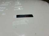 a sticker on the hood of a white car