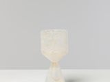 a white marble cup sitting on top of a white table