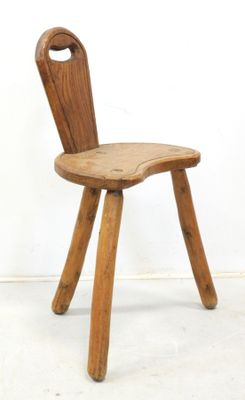 a wooden chair with a bent back and a wooden seat