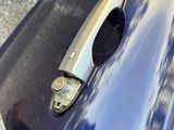 a close up of a door handle on a blue car