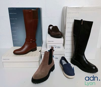 three pairs of women ' s boots and a box of shoes