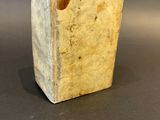 a small wooden block with a hole in the middle