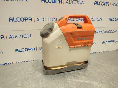 an orange and white machine sitting on top of a metal surface