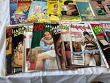 a lot of magazines on a bed with a white sheet