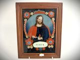 a picture of jesus in a frame hanging on the wall