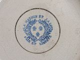 a blue and white plate with a blue border around it