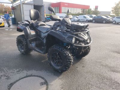an image of a black four wheeler atv parked in a parking lot