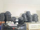 several pots and pans are stacked on a shelf in a kitchen