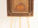 an old wooden easel with a painting on it on a white background