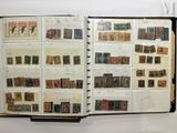 an open book with stamps on it on a table