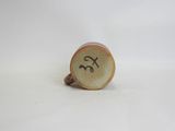 a close up of a small cup with a smiley face on it