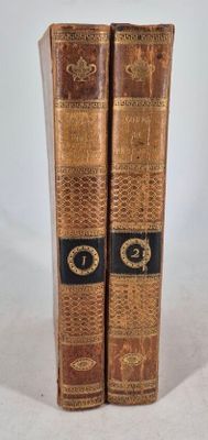 two old books that are sitting on a table