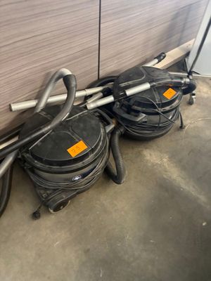 two vacuums that are on the floor next to each other