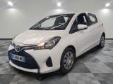 the toyota yaris is parked in a clean room with a checkered floor