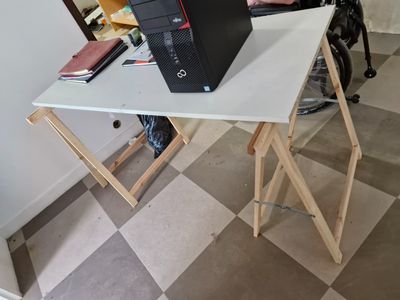 a laptop sitting on top of a table on top of a desk