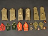 several different types of military badges are displayed on a black surface
