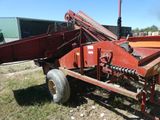 une image représentant une grande machine rouge garée dans l'herbe