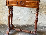 a small wooden table with a drawer on top of it