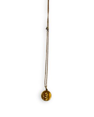 gold plated necklace with a round pendant on a long chain