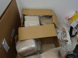 a box of food sitting on the floor next to a cardboard box