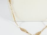 a close up of a white purse with a gold chain on it