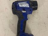 a close up of a cordless drill on a white surface