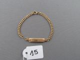 a close up of a bracelet with a tag attached to it