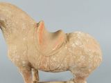 a statue of a horse with a saddle on it ' s back