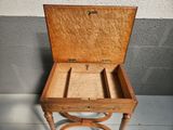 a small wooden box sitting on a stand on the floor