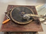 an old record player sitting on a table next to a lamp
