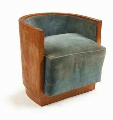 an image of a chair made of wood and blue velvet