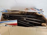 a cardboard box filled with pens and pencils