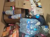 a box full of water bottles and other items in it
