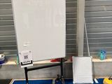 a white board sitting on a blue mat in front of a whiteboard