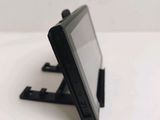 a small tablet computer on a stand on a table