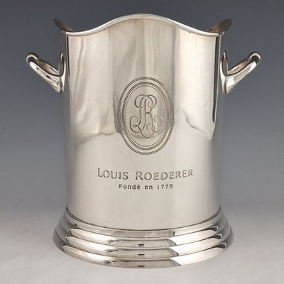 a silver ice bucket with a monogram on it