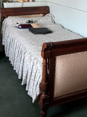 a bed with a wooden headboard and foot board in a room