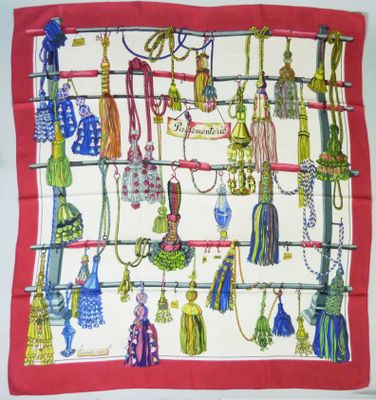 a picture of a red and white scarf with a lot of tassels on it