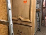 a wooden cabinet in the middle of a room