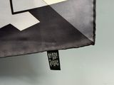 a close up of a black and white umbrella with a tag