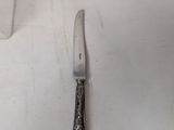 a knife that is laying on a white table