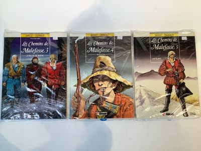 three books in a row on a white surface