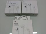 three apple earpods are sitting on top of a glass table