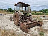 a tractor that is sitting in the dirt