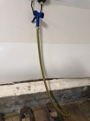 a hose attached to a wall with a hose attached to it