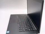 a laptop computer sitting on a table with a keyboard