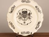 a plate with a coat of arms on it sitting on a table