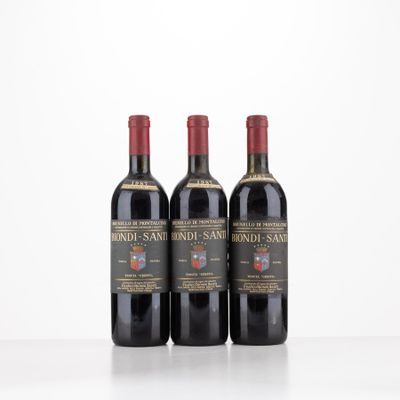 three bottles of wine sitting on top of a white table